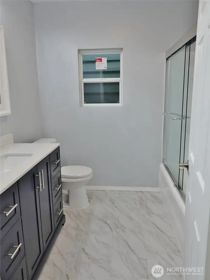 Stylish and beautuful re-done Bathroom with tile floors.