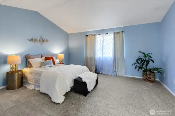 You could have dressers and a seating area and still feel spacious in this room.