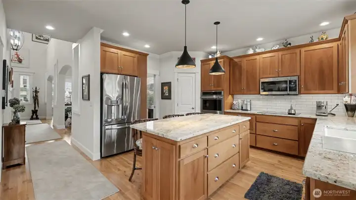 Spacious kitchen offering ample counter space to cook, and entertain with ease.  Several upgraded specialty-drawers help organize kitchen gadgets.  Upgraded with ndermount cabinet lighting, LUX appliance package, counters, light fixtures, sink, and more.  Convenient whole-house vacuum system included handy sweep-port in the kitchen.