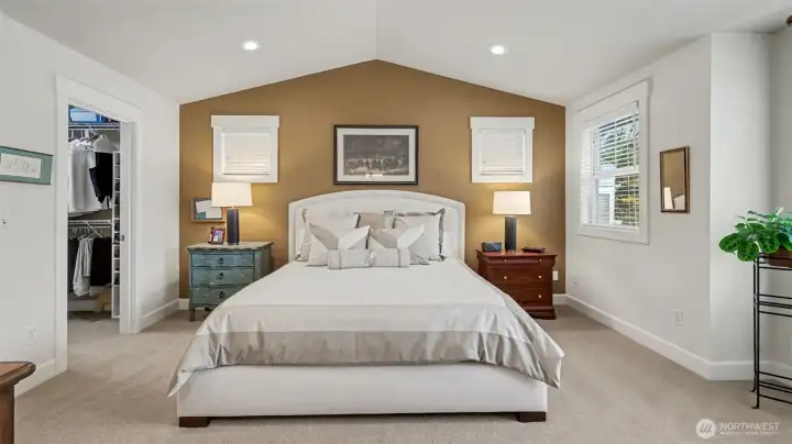 Primary bedroom featuring a walk-in closet and an en-suite bathroom.