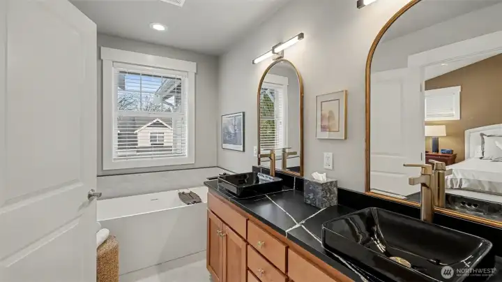 LUX primary suite - with upgrades-galore!  New flooring and wall tiles, heated floors, free-standing tub, below-cabinet lighting, new counters, sinks, fixtures and mirrors.
