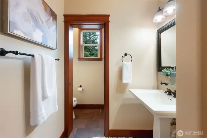 The main level bathroom with a separate shower area.