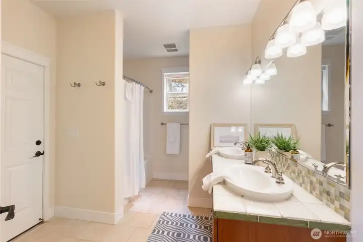 The full bathroom downstairs has deck access for those coming in from the lake.