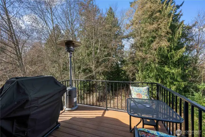 Deck with tranquil greenbelt views.