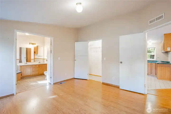 Primary Bedroom with french doors leading to primary bathroom.