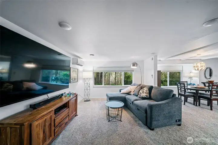There is room to entertain a crowd in the spacious living area. This space is open to the dining and kitchen, and it features a door to the large wrap around, covered deck