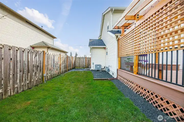 Spacious side yard. Ideal RV parking space, batting cage, or dog run.