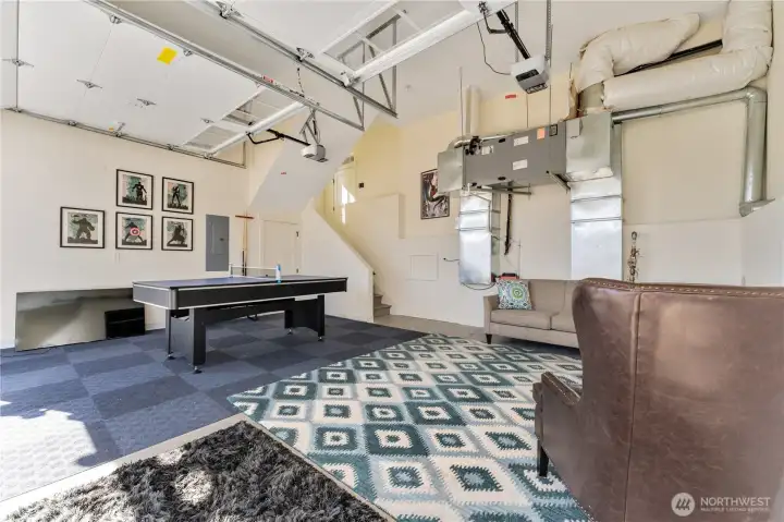 View of attached 2-car garage with lounge and game area.