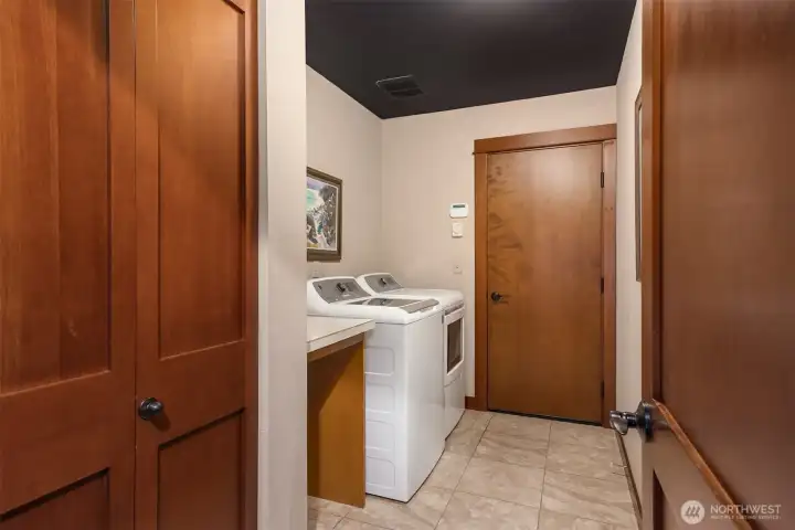 Spacious laundry room with 2 car garage through door.