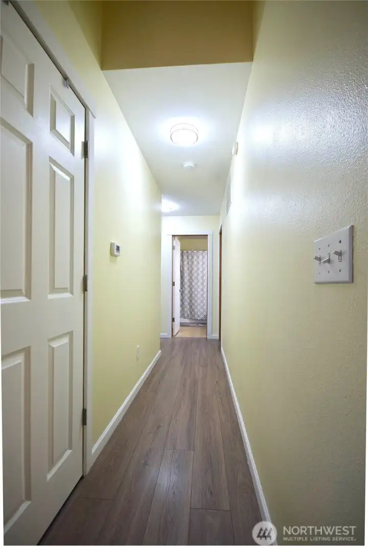 Interior hallway connecting the main living areas to the bedrooms.