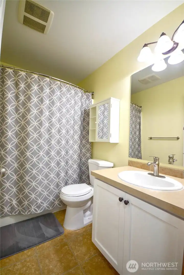 Convenient hallway bathroom with full amenities for family and guests.