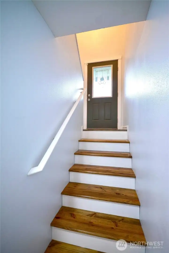 Perspective from the downstairs area showcasing the inviting front door and entryway.