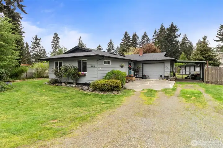 Rambler with one car garage and carport on a large double lot