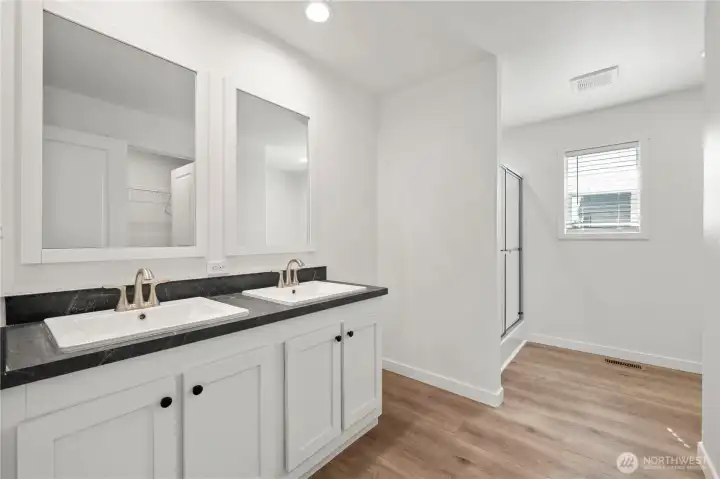 Primary Bathroom with double sink vanity and walk-in closet