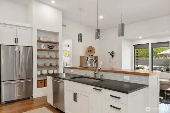 Kitchen island connected to extra living & patio views