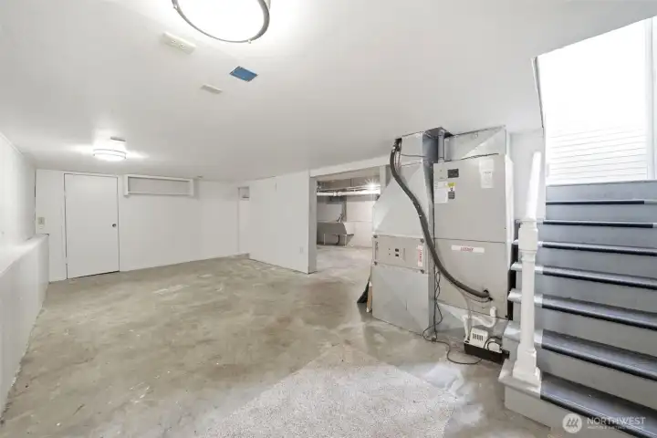 Full basement with utility sink, the furnace and water heater.