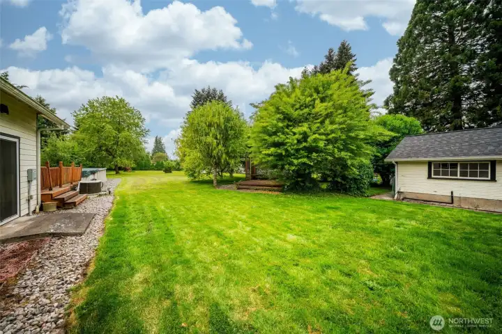 Beautiful fenced backyard with decks, pool, shed, and mature landscaping!