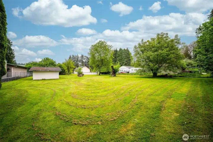 Beautiful fenced backyard with decks, pool, shed, and mature landscaping!