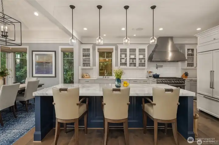 The chef's kitchen is as stunning as it is functional-gleaming with white marble countertops that crown an oversized island. Two subzeros, two sinks and three ovens makes entertaining a breeze! The chef's kitchen is as stunning as it is functional-gleaming with white marble countertops that crown an oversized island. Two subzeros, two sinks and three ovens makes entertaining a breeze!