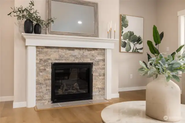 There is a stone surround and mantle.  There is an electrical outlet above the fireplace and smurf tube for no cord view if you choose to mount your tv above the fireplace.