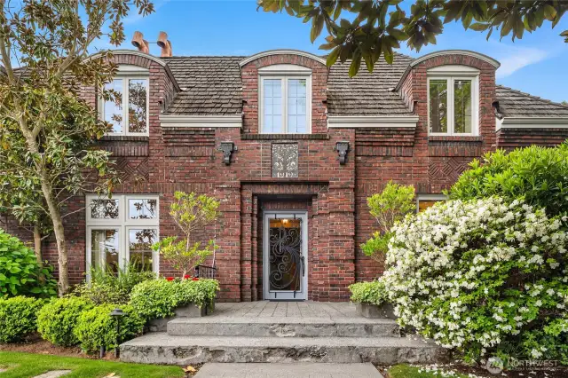 Such stunning curb appeal.  I love the curve of those dormers and the backlit house number in wrought iron over the front door!