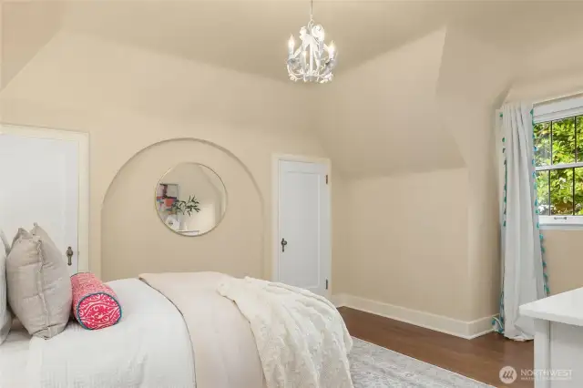This bedroom has its own bathroom and small desk area.