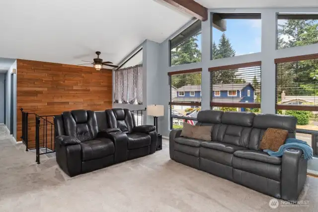 Warm wooden wall and clear story window welcomes you in to this bright & open home