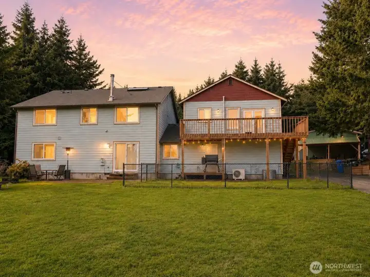 Rear of home. Welcome to 7531 152nd Ln SE, Tenino. Gated 5.2-acre estate with 5 potential bedrooms + 1br ADU, shop, solar, and fiber Optic high speed internet. Offering privacy, flexibility, and energy efficiency