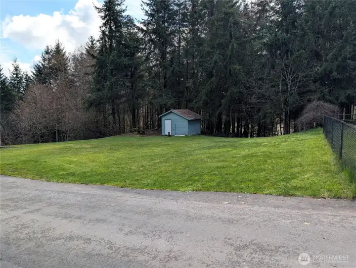 Yard area, well house & RV parking with a 30 amp service next to the well house