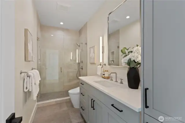 Elegant 3/4 bath serves the secondary bedrooms, featuring high end finishes, and a toto washlet.