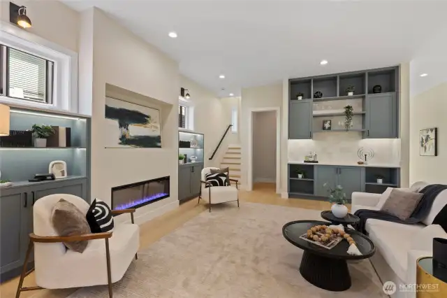 Expansive living room features sweeping cielings and a sleek electric fireplace-creating a bright, airy, and inviting space. Perfect for both relaxation and entertaining.