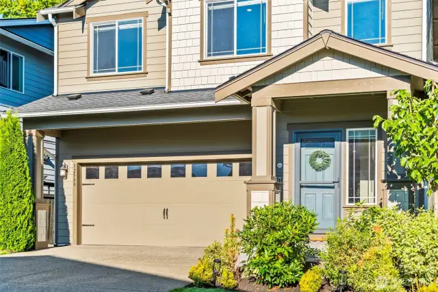 Close-up of front exterior details, including modern windows, and stylish garage doors.