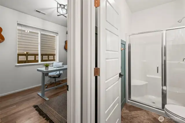 Updated bathroom with glass shower enclosure, modern tile, and sleek finishes.
