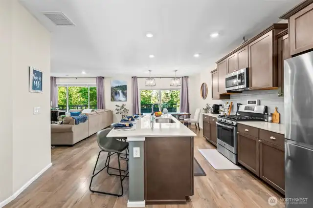 Open-concept kitchen layout with oversized island and pendant lighting, ideal for entertaining.