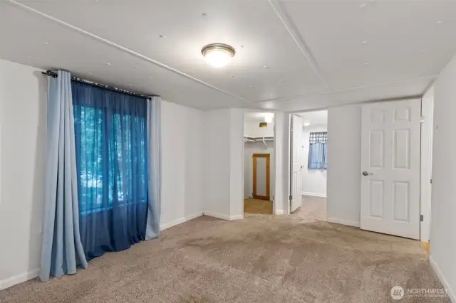 Primary bedroom with a walk in closet and attached private bath.