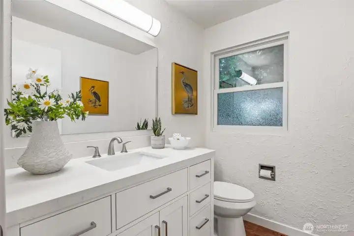The main floor bathroom is classy, updated, and tucked out of the way.