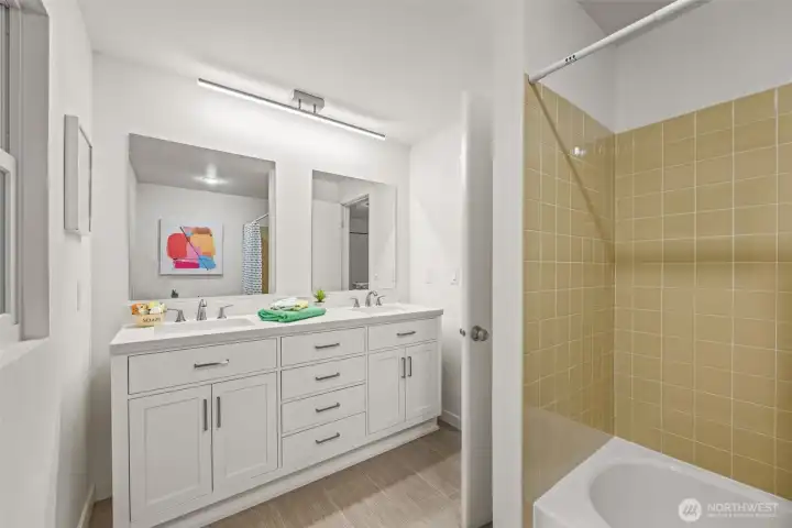 The main bathroom upstairs provides double sinks, loads of storage, and space to spare!