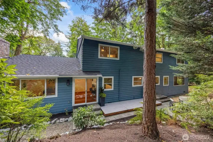 The back of this wonderful home is a visage of serenity, like an escape to a state park with all the creature comforts of home.