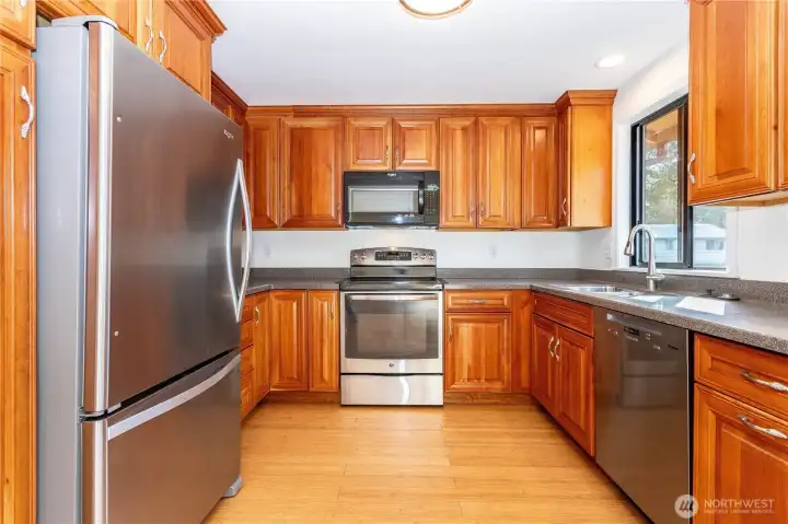 Updated kitchen with stainless steel appliances accented with beautiful Cherry cabinets