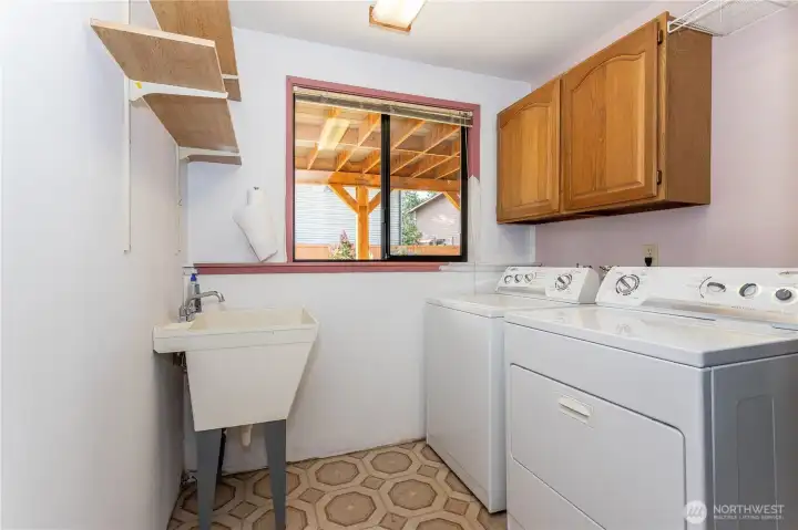 lower level laundry with laundry sink.
