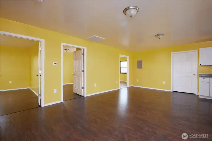 Upper Unit Living Room. Looking West at entrance to 3 Bedrooms.