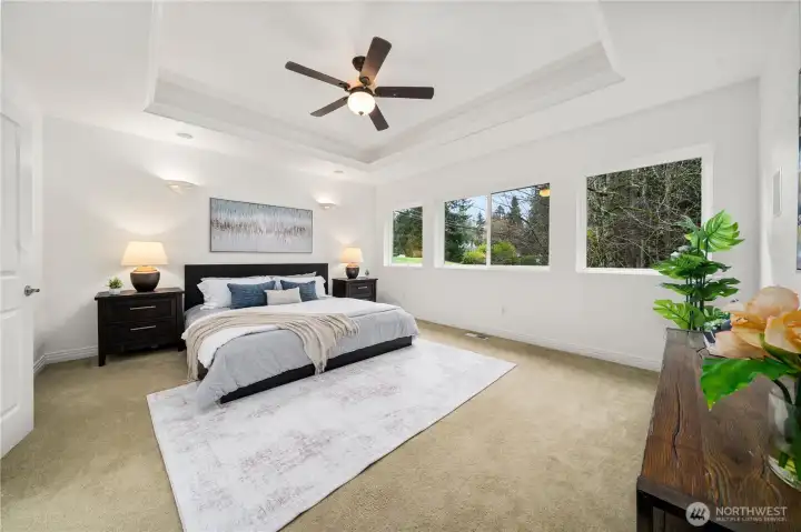 The primary suite offers a walk-in closet & a newly updated spa-inspired five-piece bath.