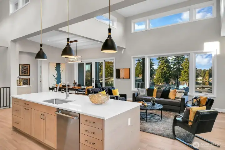 Enjoy lake views from behind your quartz counter top island.  Island features; Low profile sink, GE Cafe SS dishwasher, garbage/recycling pull out + more drawers and storage!