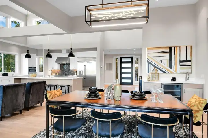 Main level formal dinning with wet bar & Fredrick Raymond LED Abstract Chandelier.
