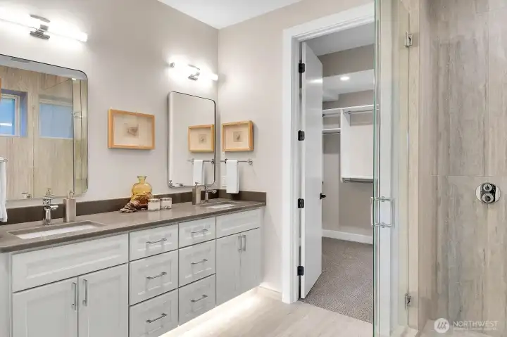 Lower level primary ensuite, quartz double sink vanity with light sensor floor lighting and walk-in closet.