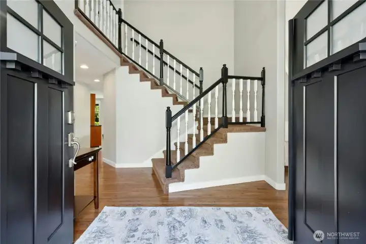 Refreshed hardwood floors in an espresso color, new front doors and look at the 2 story entry.