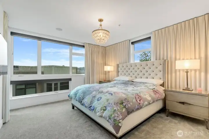 Sunny and bright primary suite. But for a restful sleep enjoy remote controlled blackout blinds.