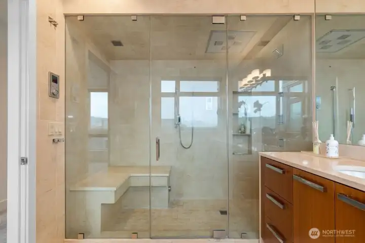 The primary ensuite is a true retreat, featuring a spa-inspired ¾ en-suite bath with steam shower and classic travertine natural stone, radiant floor hea