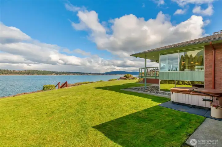 The huge lot offers a level, generous backyard — an uncommon luxury on waterfront property.