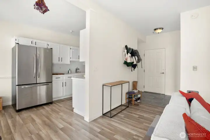 From Living Room facing front door and kitchen. Ez maintenance laminate flooring.